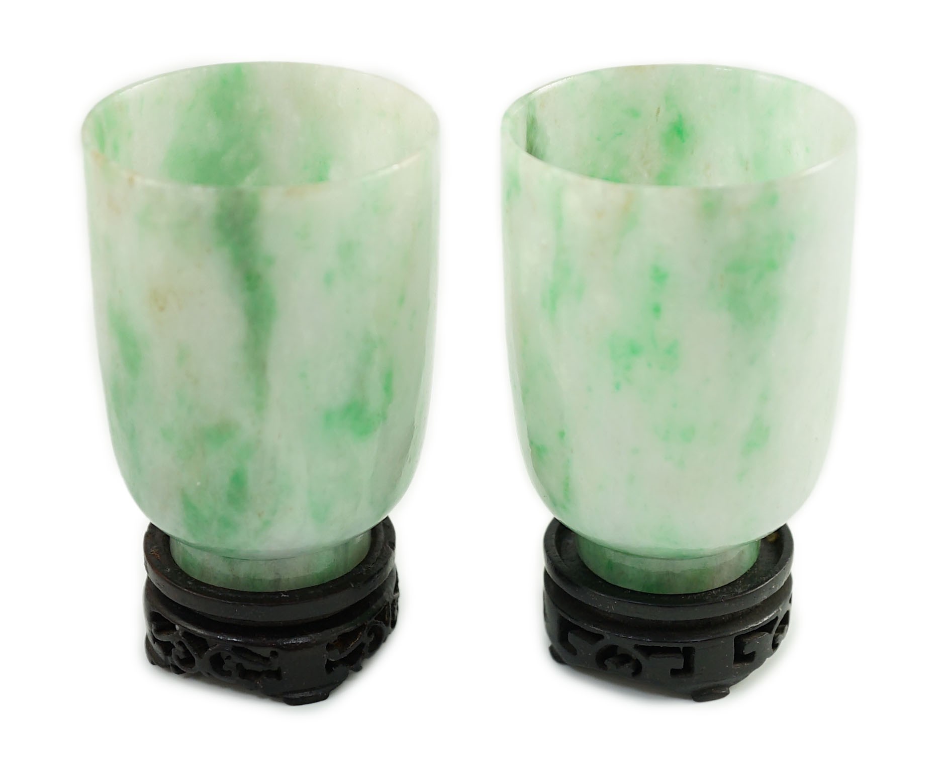 A pair of Chinese jadeite cups, 6.2cm high, wood stands, fitted box